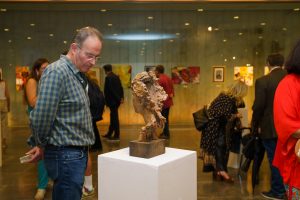 Uno de los visitantes de la muestra observa el busto de Pepa Pinto que se exhibe en la exposición